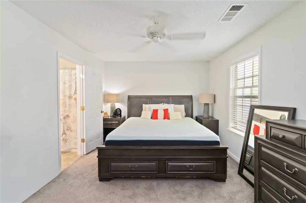 3752 Berkeley Crossing Duluth, GA 30096 - Photo 20 of 23 a bedroom with a bed and a chandelier