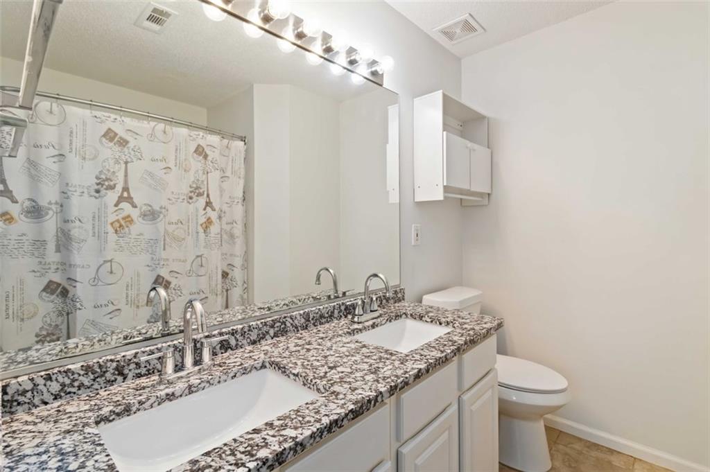 3752 Berkeley Crossing Duluth, GA 30096 - Photo 9 of 23 a bathroom with a granite countertop sink and a mirror