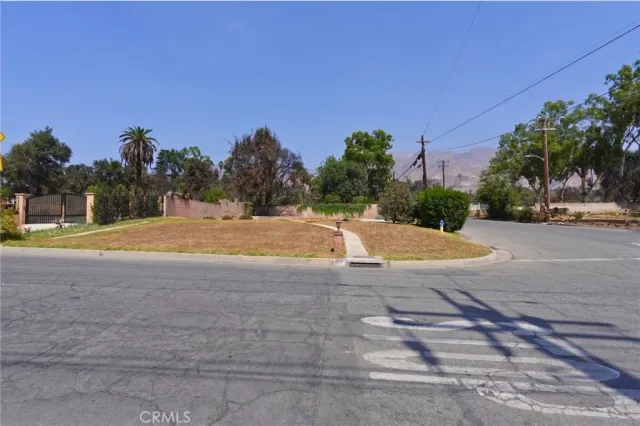 a view of swimming pool with outdoor seating and house in the background