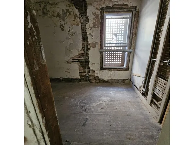 a view of an empty room and a window