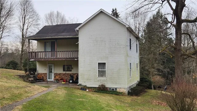a view of a house with backyard porch and sitting area