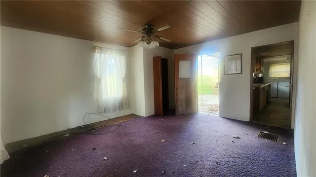 an empty room with windows and closet