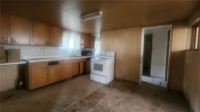 a kitchen with a sink a stove and refrigerator