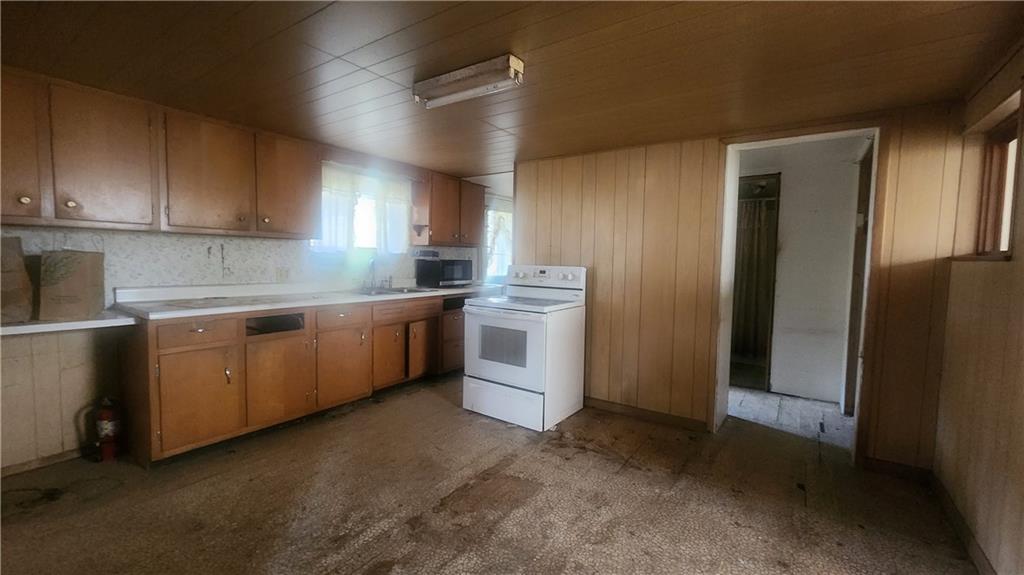 140 High Street Avonmore, PA 15618 - Photo 8 of 19 a kitchen with a sink a stove and refrigerator