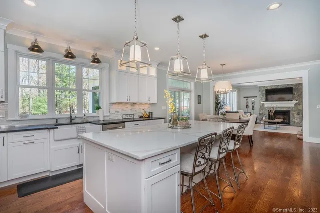 a kitchen with a table chairs stove and wooden floor
