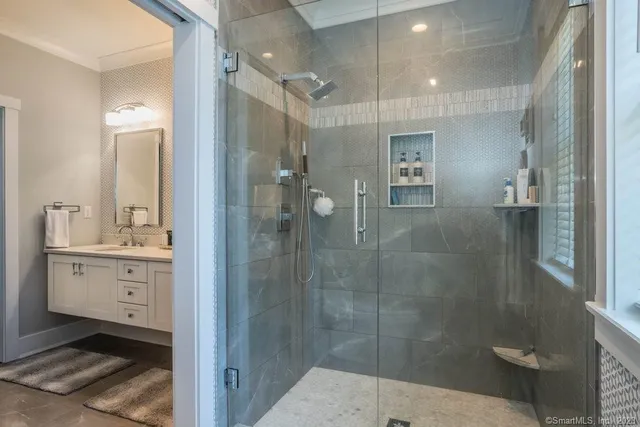 a bathroom with a shower sink and mirror