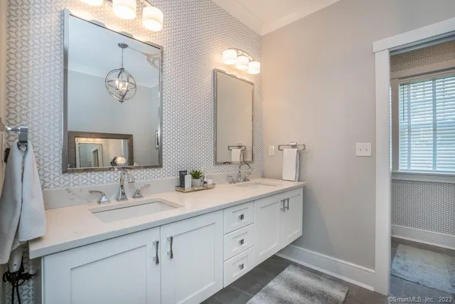 a bathroom with a double vanity sink and a mirror