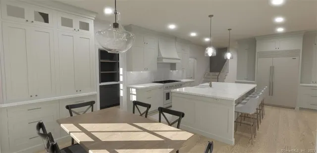 a kitchen with a table chairs sink and cabinets