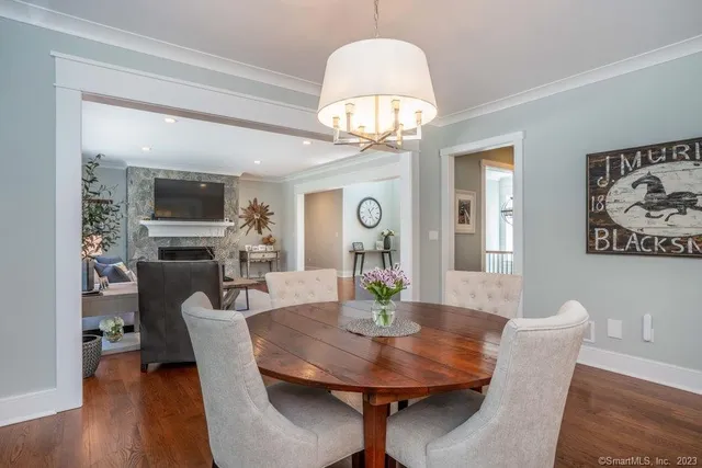 a view of a dining room with furniture wooden floor and chandelier