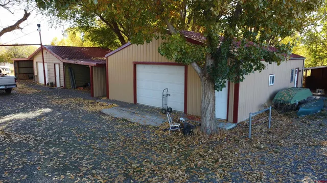 a view of a house with a backyard and a tree