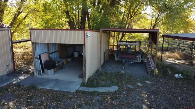 a view of a porch with furniture and a yard