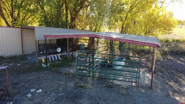 a view of a patio with a table chairs and a backyard