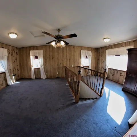 a view of a livingroom with furniture and staircase