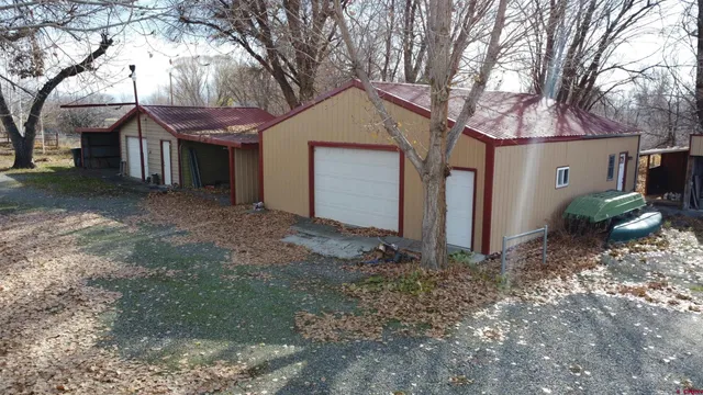 a view of a house with a yard covered in snow