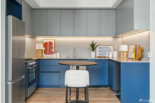 a kitchen with stainless steel appliances granite countertop a refrigerator and a stove