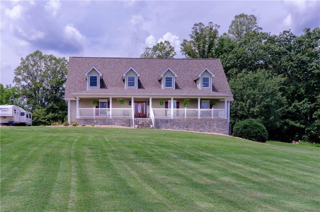 6673 Jenkins Road Morganton, NC 28655 - Photo 1 of 32 a front view of a house with a garden