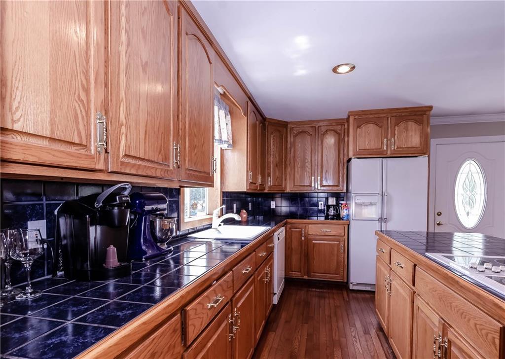 6673 Jenkins Road Morganton, NC 28655 - Photo 12 of 32 a kitchen with granite countertop a sink stainless steel appliances and cabinets