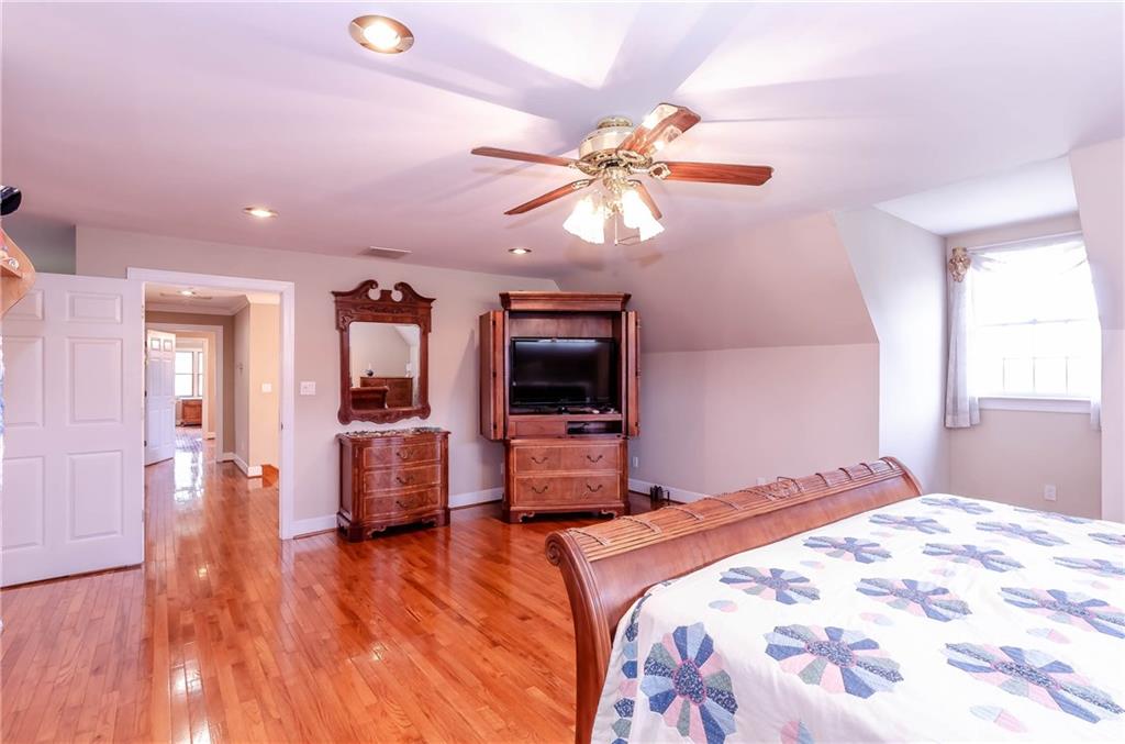6673 Jenkins Road Morganton, NC 28655 - Photo 19 of 32 a bedroom with a bed and a chandelier