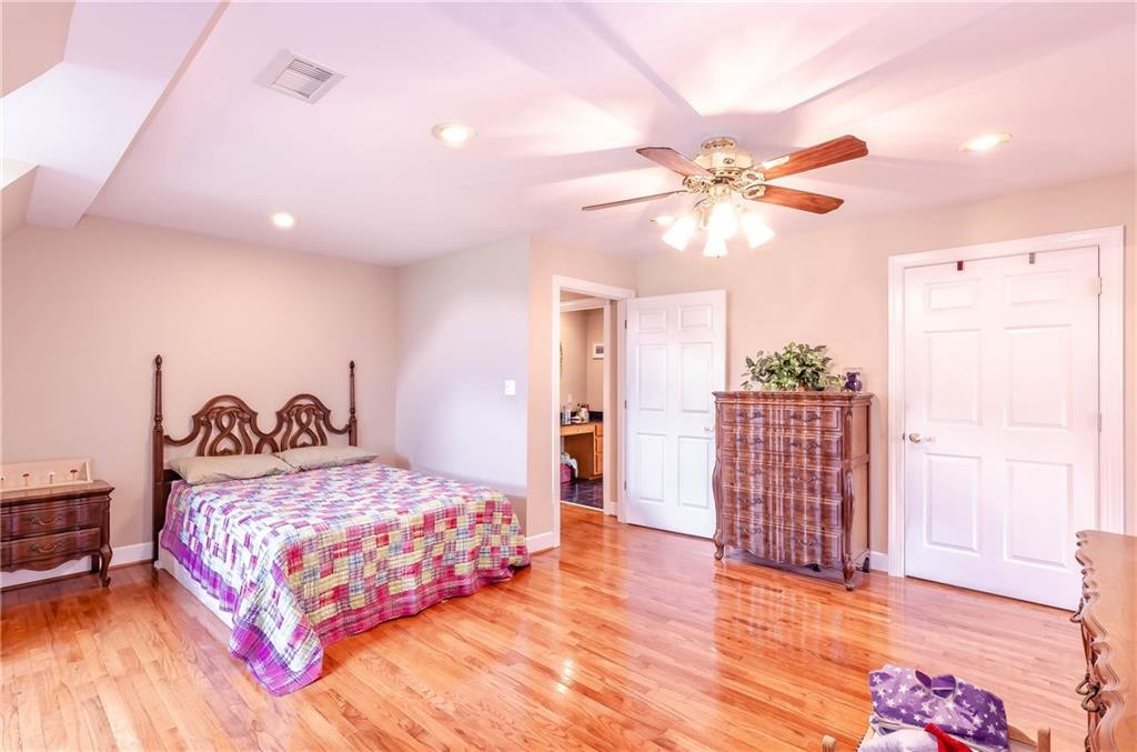 6673 Jenkins Road Morganton, NC 28655 - Photo 22 of 32 a bedroom with a bed and a chandelier