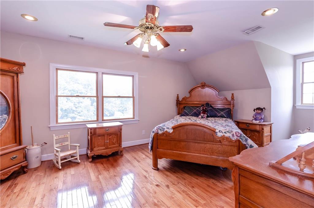 6673 Jenkins Road Morganton, NC 28655 - Photo 23 of 32 a bedroom with a bed and wooden floor