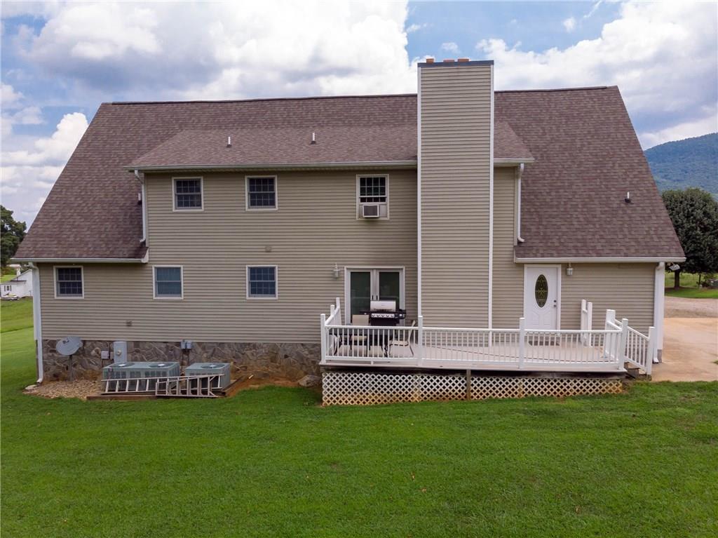 6673 Jenkins Road Morganton, NC 28655 - Photo 29 of 32 a front view of a house with a garden and plants