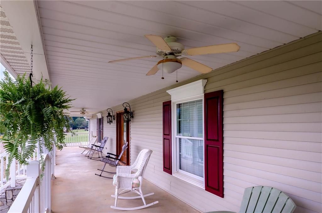 6673 Jenkins Road Morganton, NC 28655 - Photo 6 of 32 a view of a patio with table and chairs with wooden floor and plants