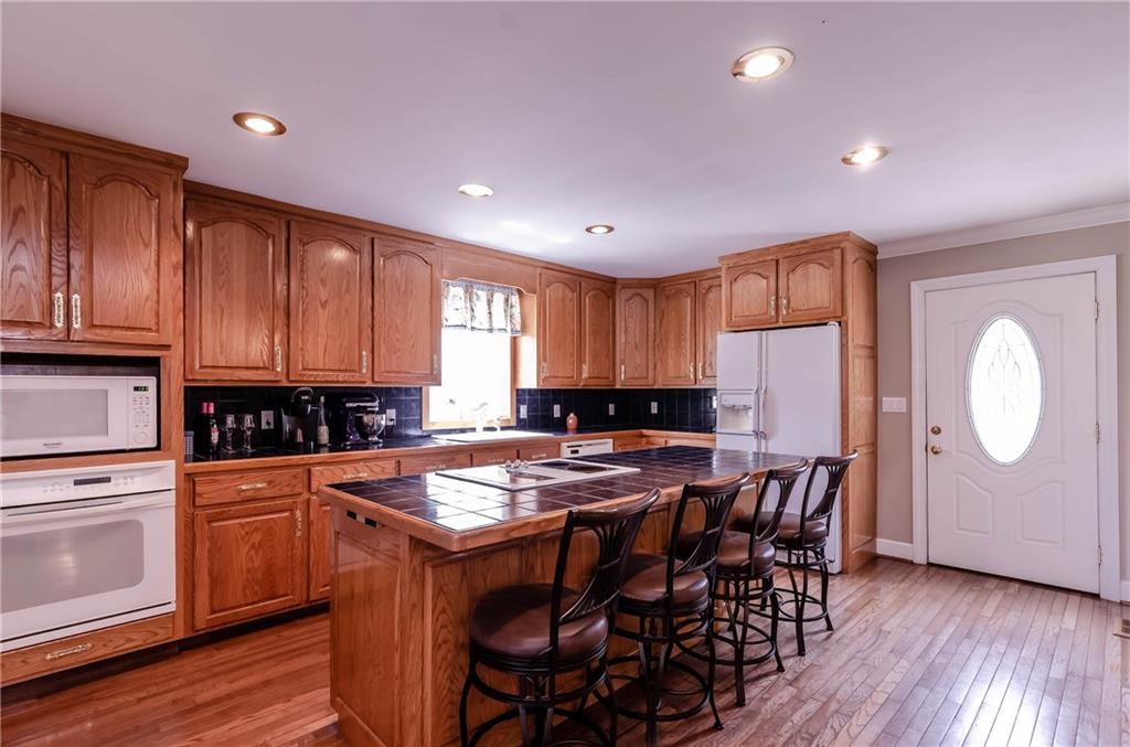 6673 Jenkins Road Morganton, NC 28655 - Photo 10 of 32 a kitchen with a table chairs refrigerator and cabinets