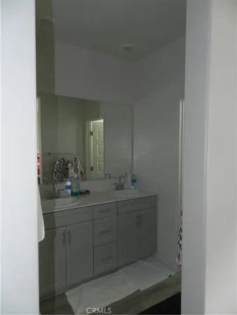 a bathroom with a toilet a sink a mirror and vanity