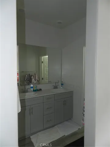 a bathroom with a toilet a sink a mirror and vanity