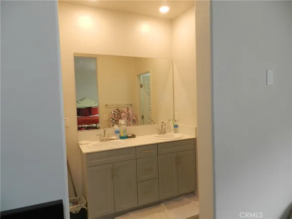 a bathroom with a double vanity sink and a mirror