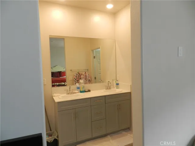 a bathroom with a double vanity sink and a mirror