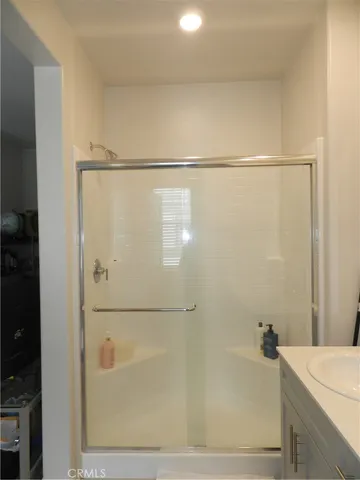 a bathroom with a shower and a bath tub