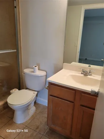 a bathroom with a sink toilet and a mirror