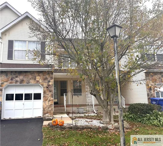 a view of a house with a yard and sitting area
