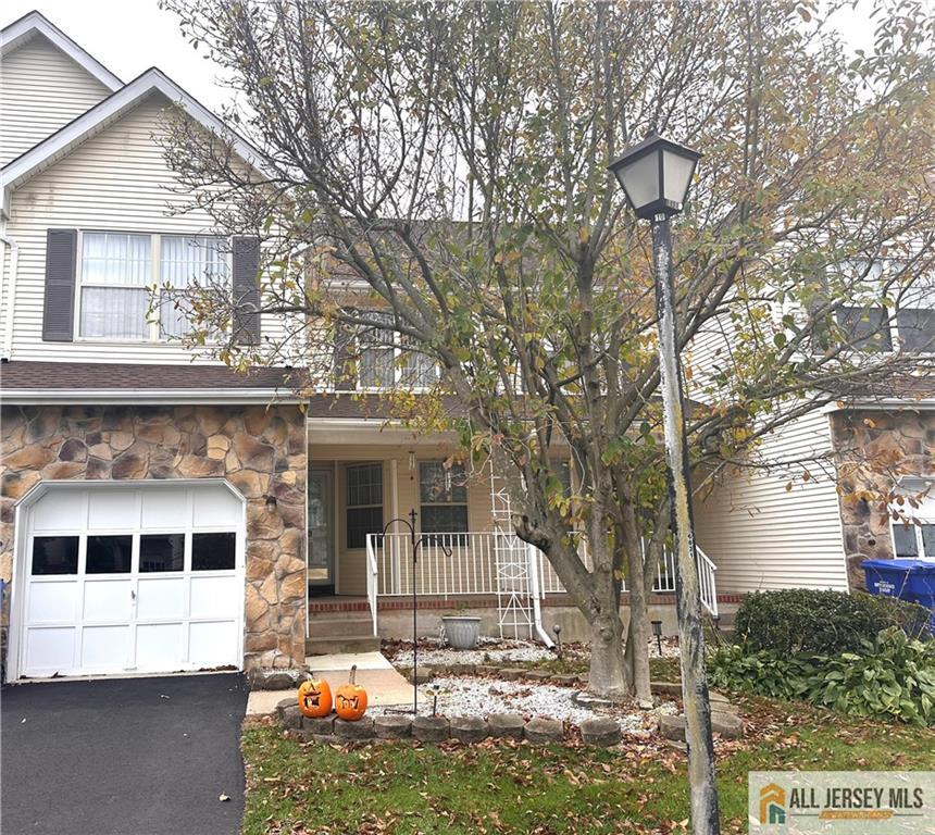 a view of a house with a yard and sitting area