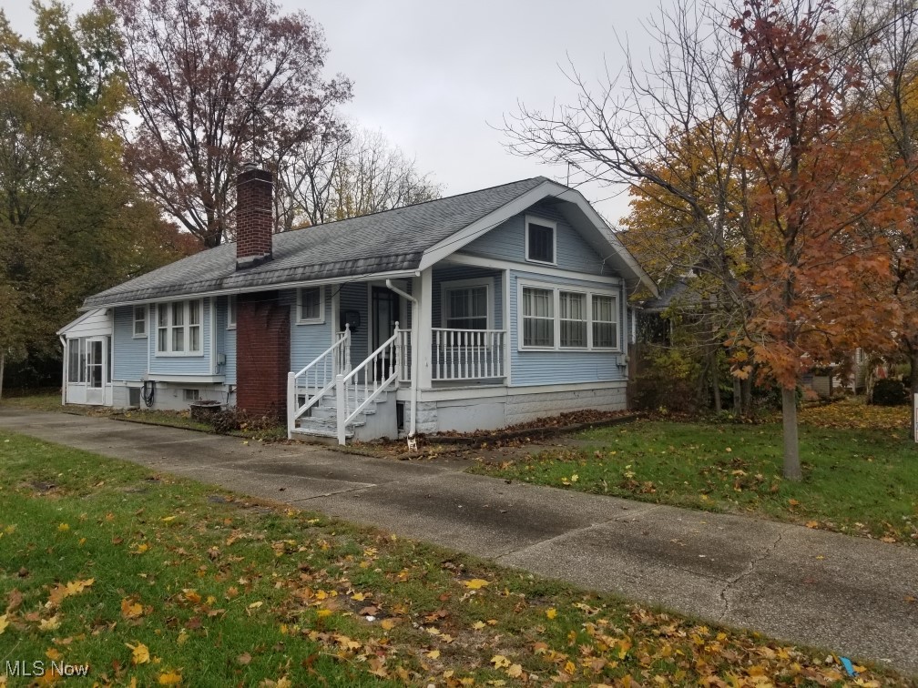 218 Canton Road Akron, OH 44312 - Photo 1 of 19 Bungalow featuring a front lawn, a chimney, and roof with shingles