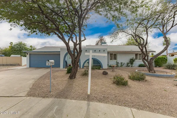 a view of a house with a tree beside it