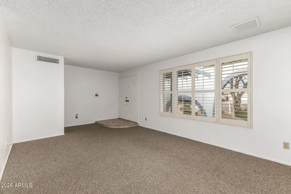 a view of an empty room with a window
