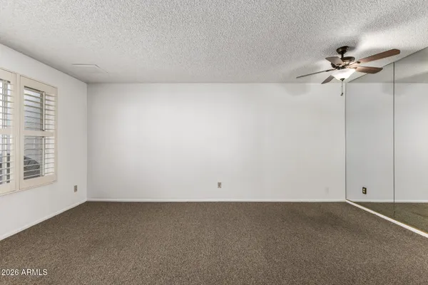 an empty room with a empty space and a ceiling fan