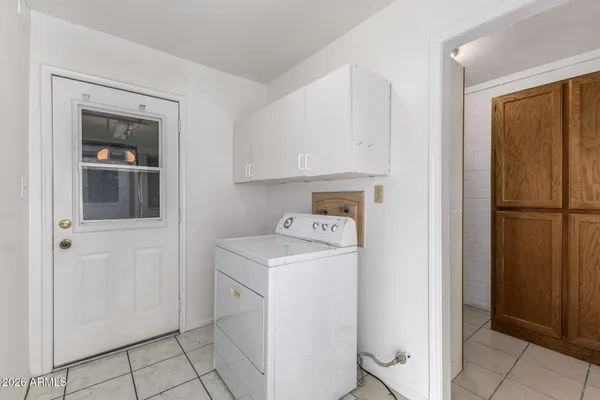 a view of a storage and utility room with washer and dryer