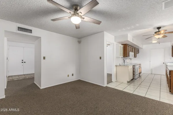 a view of a kitchen with a sink and a chandelier fan