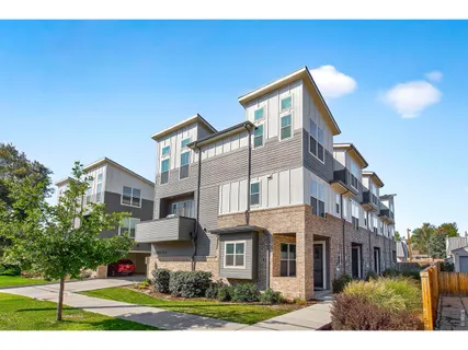 a front view of a residential apartment building with a yard