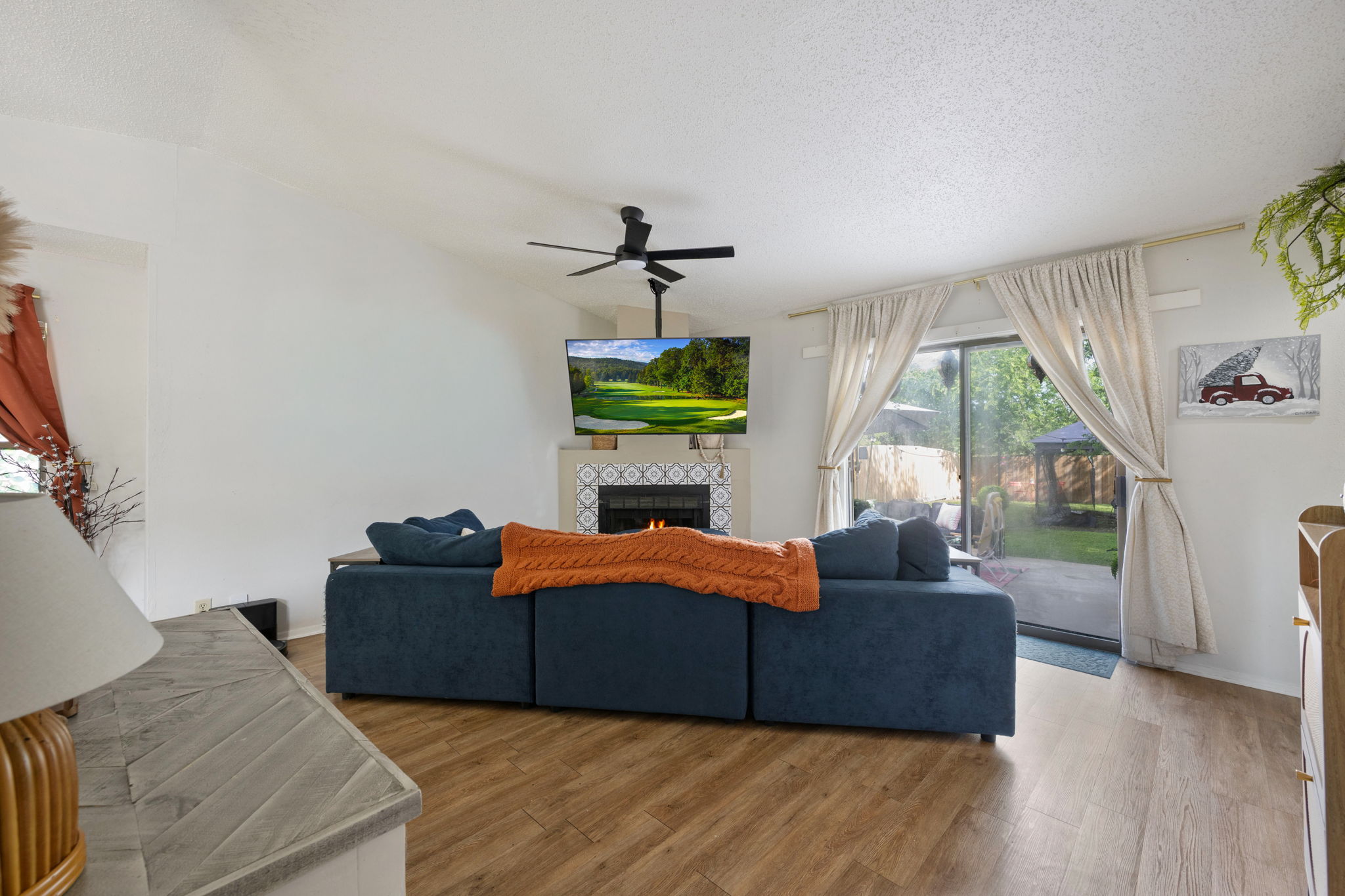 8317 Forest Ridge Drive San Antonio, TX 78239 - Photo 5 of 26 Cozy living area boasts a stylish fireplace and sliding glass doors that open to a verdant outdoor space.