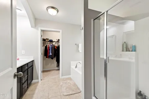 a view of a hallway with closet and a living room