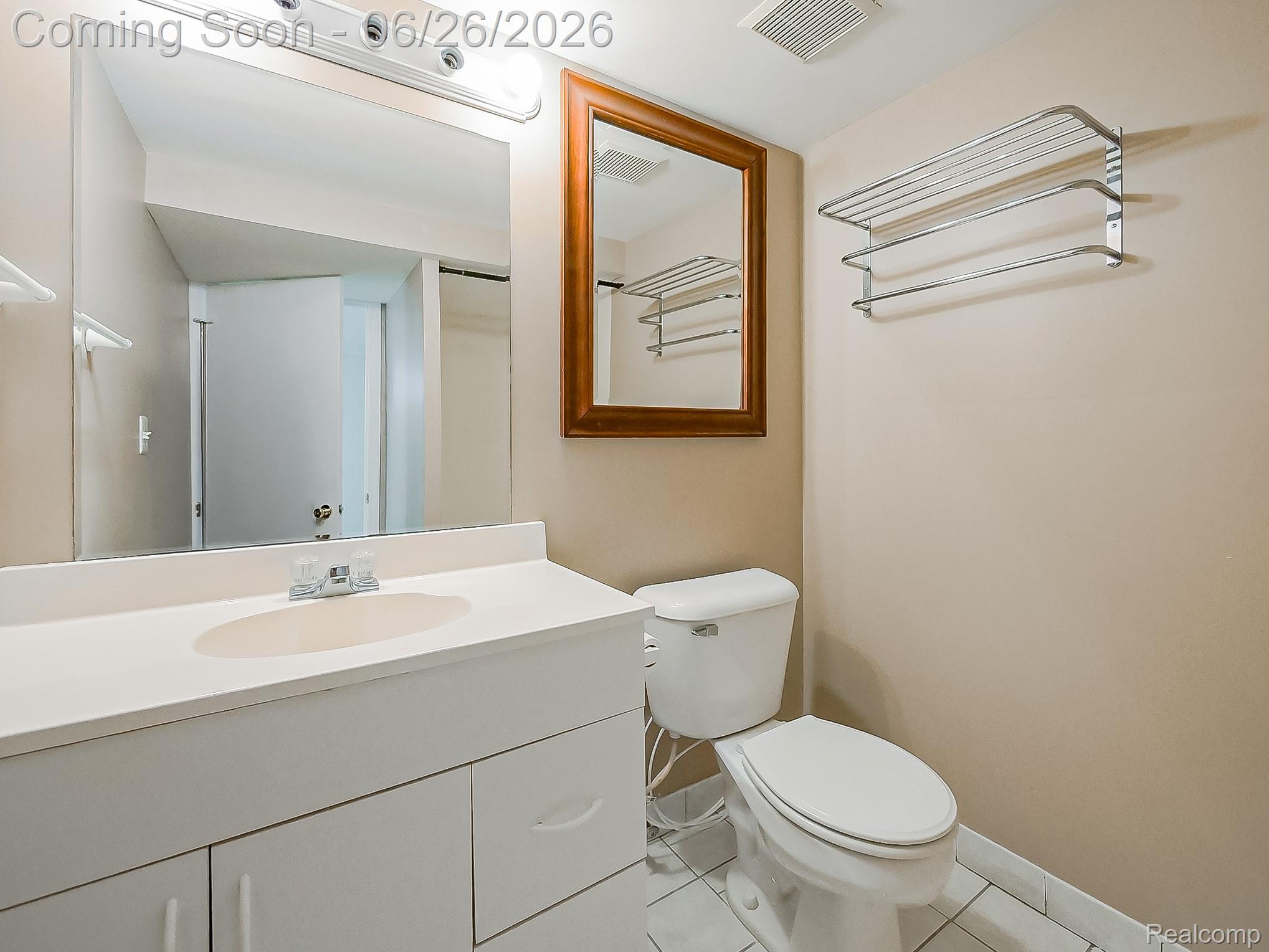 160 Pine Tree Ridge, Unit 3 Waterford, MI 48327 - Photo 15 of 26 Vanity with integrated sink, chrome faucet, and expansive wall mirror