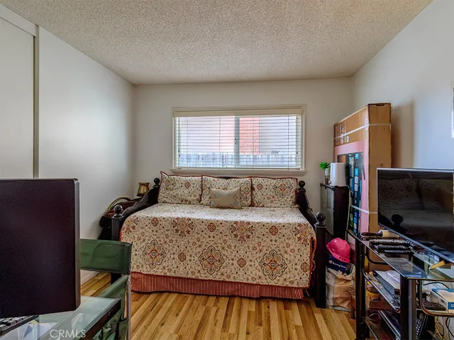 a bedroom with a bed and a flat screen tv