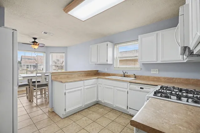 a kitchen with sink cabinets and window