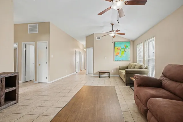 a living room with furniture and a chandelier