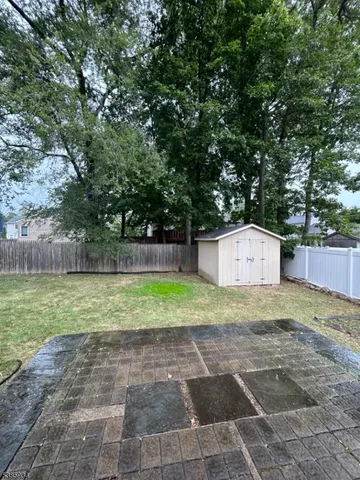 a view of a backyard with large trees