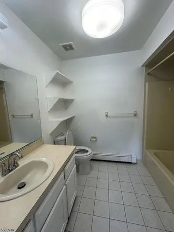 a bathroom with a sink toilet and mirror